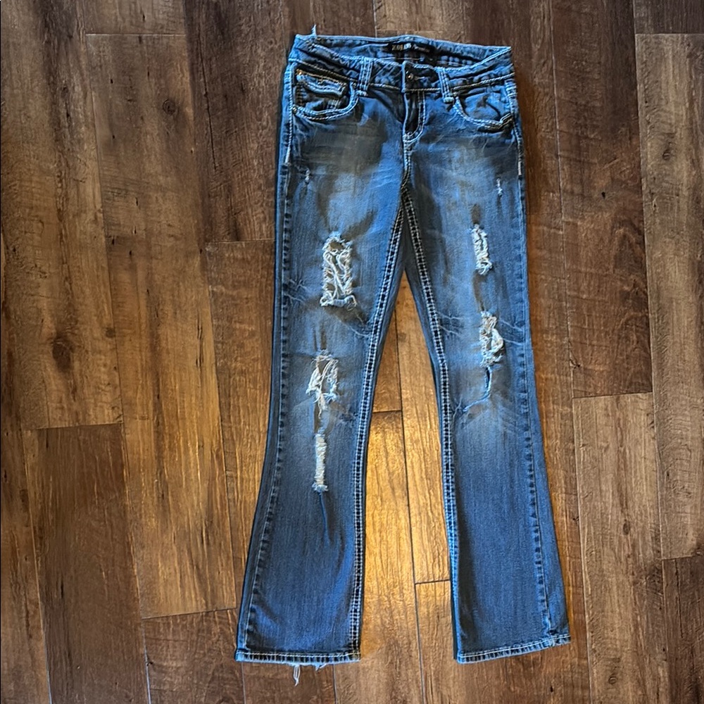 Blue Boot Cut Jeans with Distressed Detailing